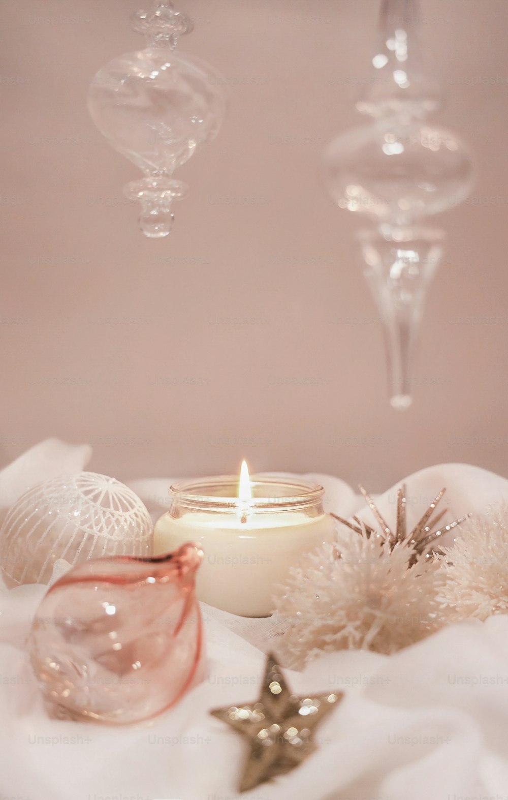 a lit candle sitting on top of a white cloth