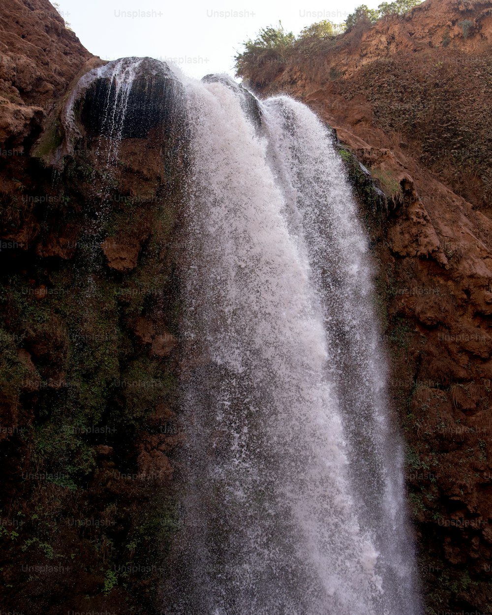 una cascata molto alta con molta acqua che esce da essa