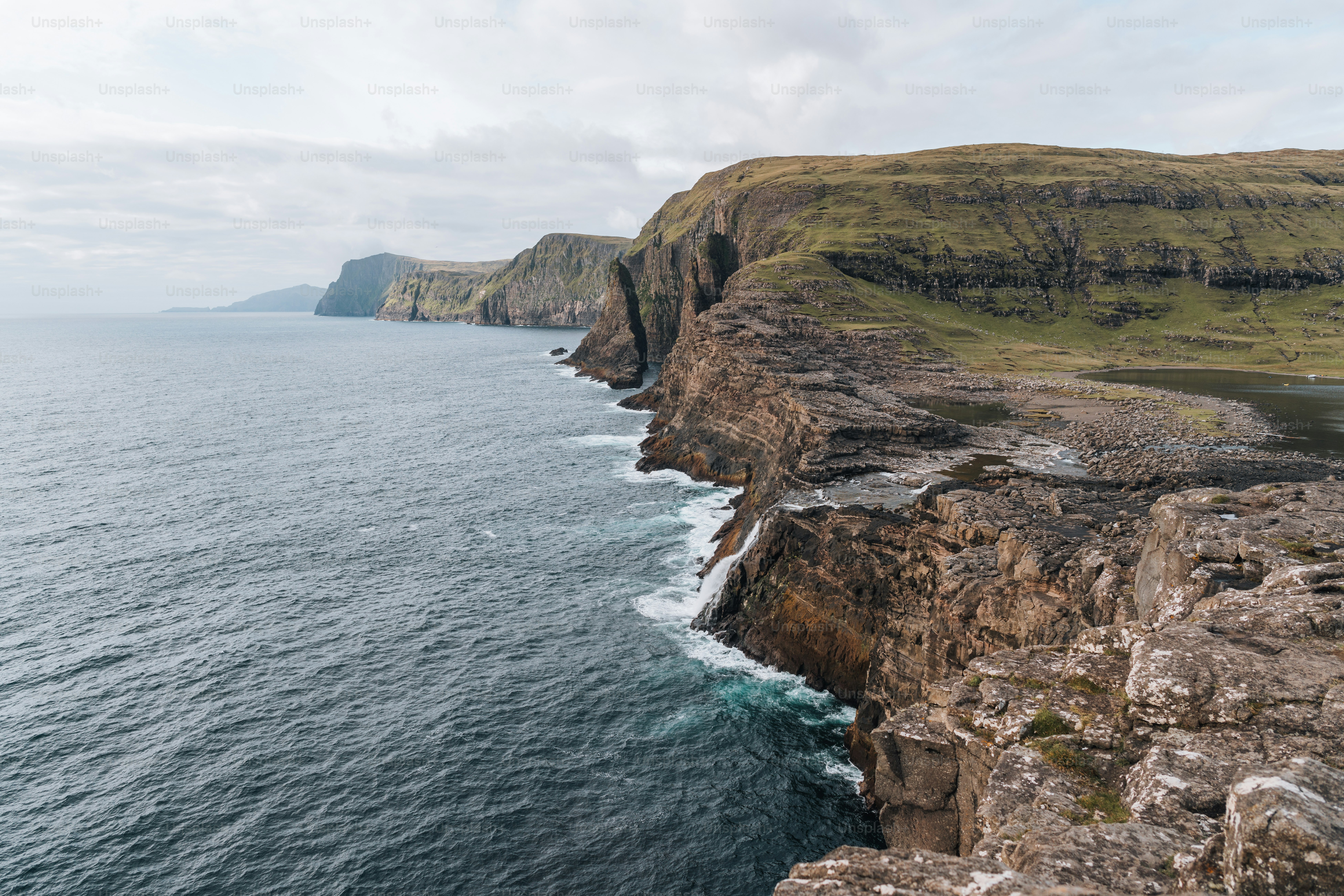 a rocky cliff overlooks a body of water