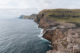 a rocky cliff overlooks a body of water