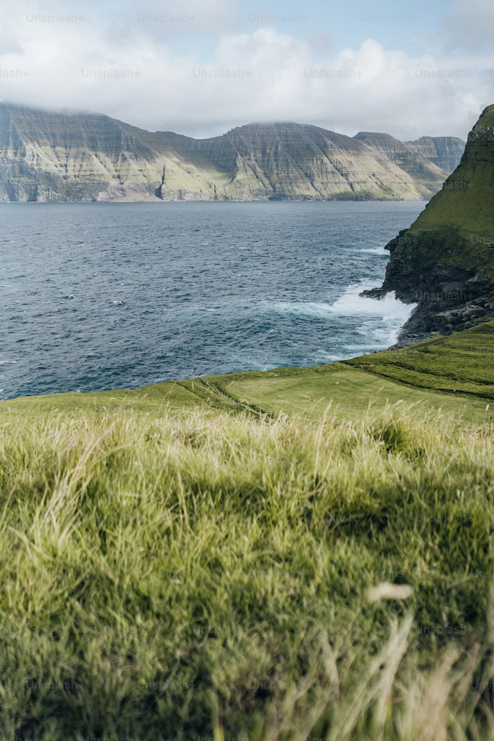 a view of a body of water with mountains in the background