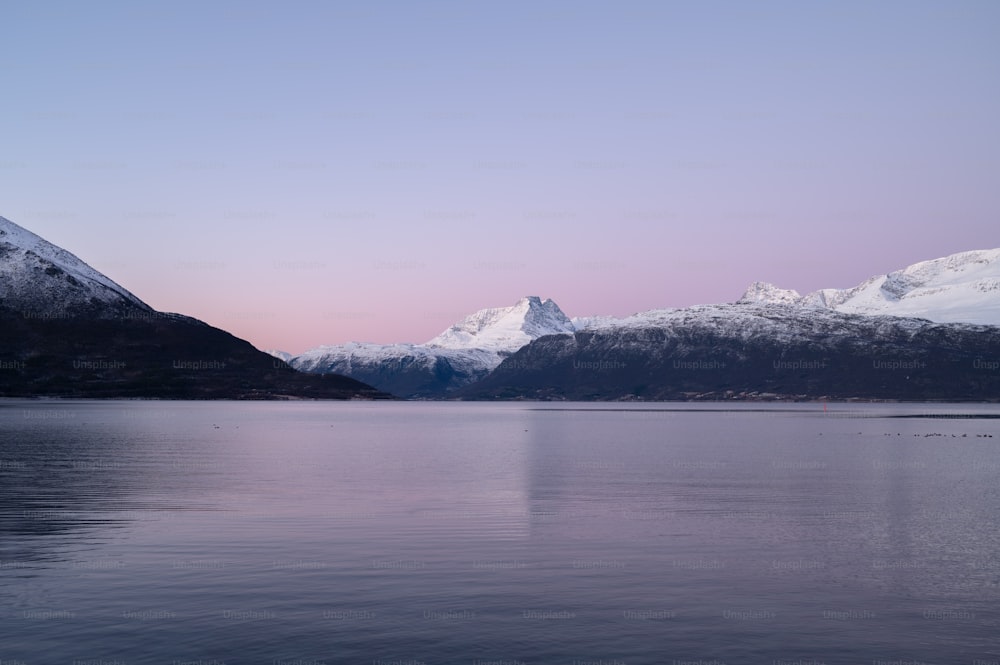 a large body of water with mountains in the background