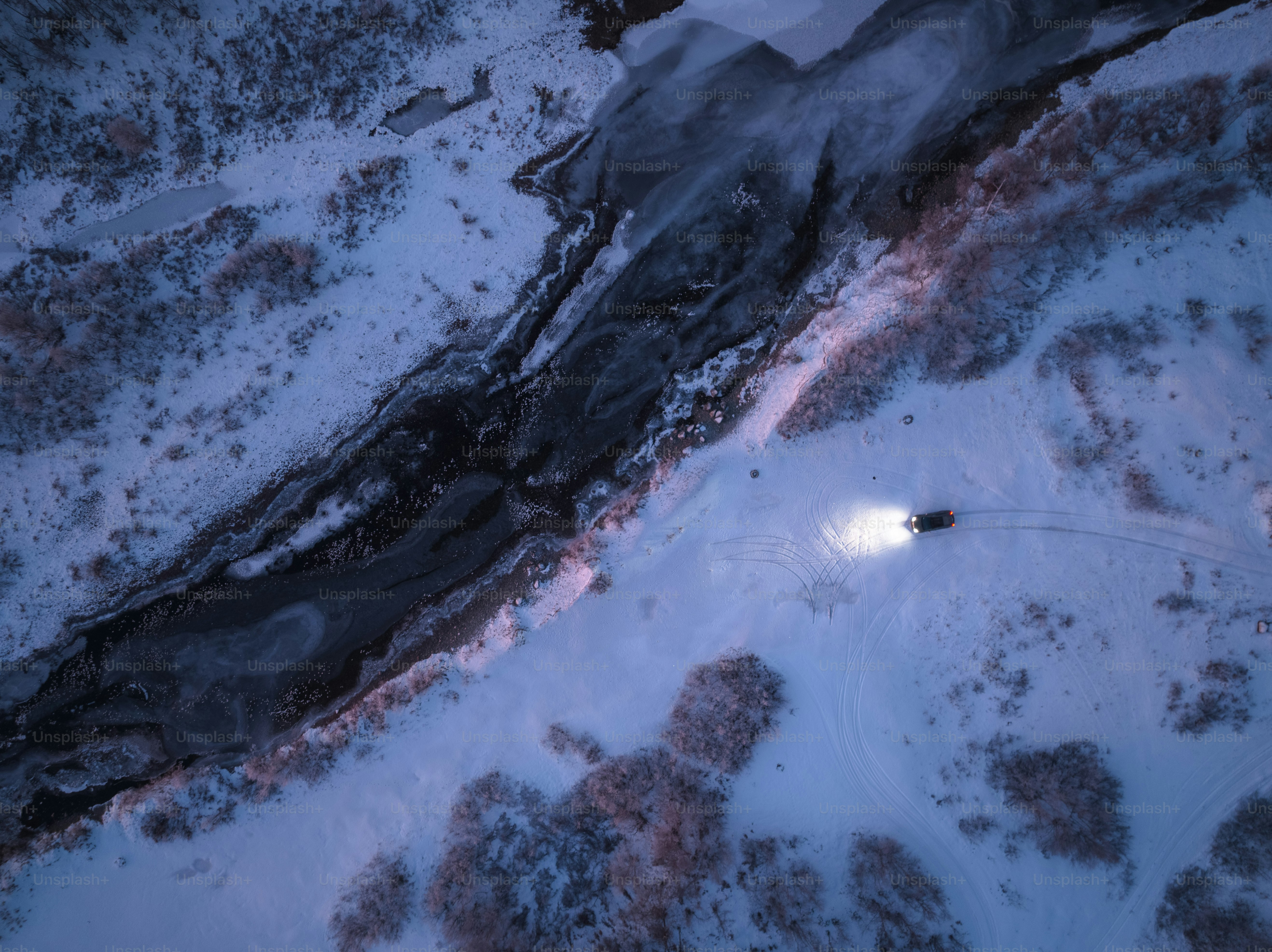 an aerial view of a snow covered field