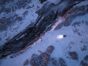 an aerial view of a snow covered field