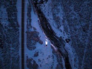 an aerial view of a road in the snow