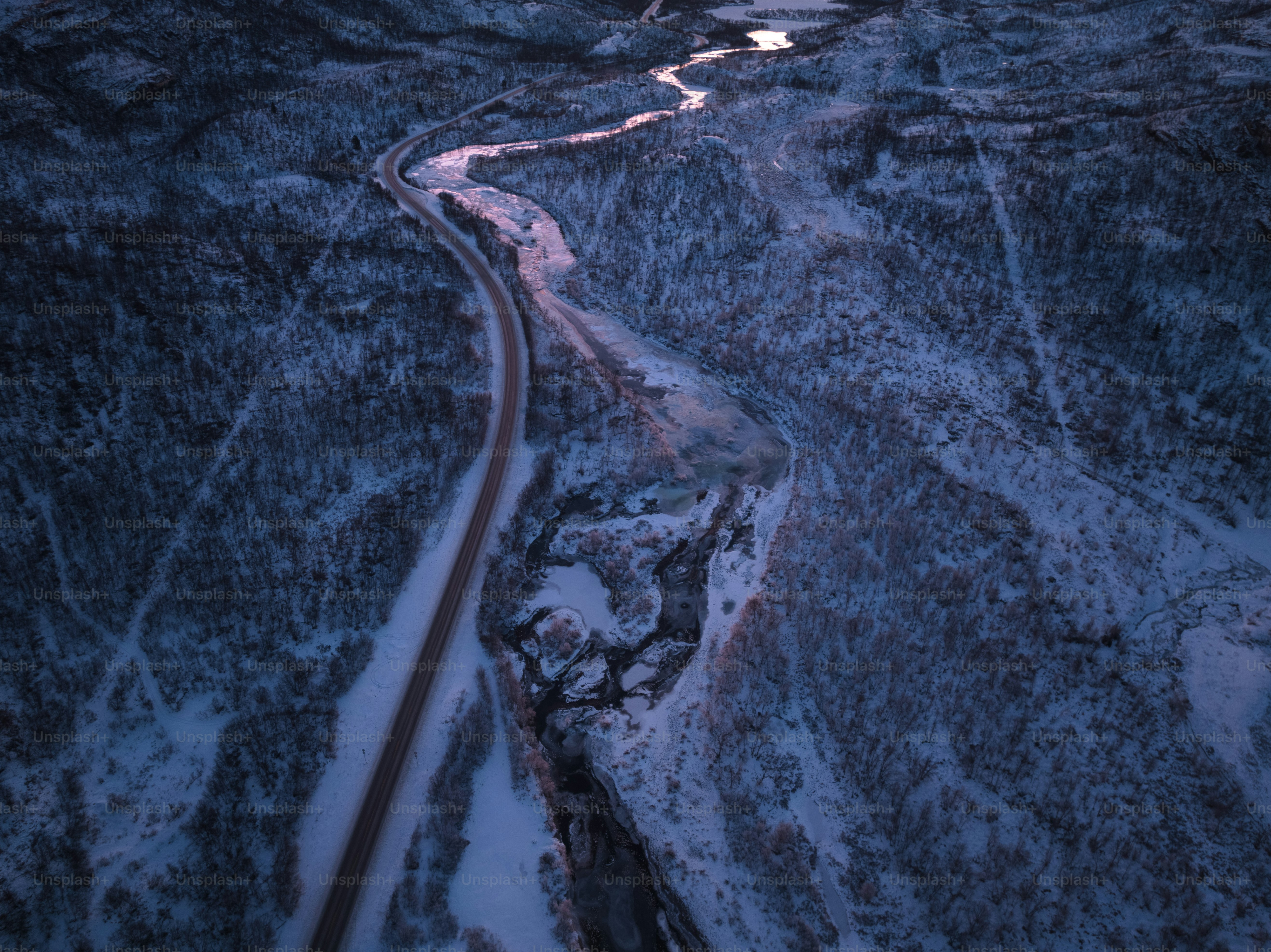An aerial view of a road in the snow photo – Winter Image on Unsplash