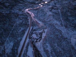 an aerial view of a winding road in the snow