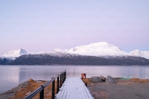 a wooden dock sitting next to a large body of water