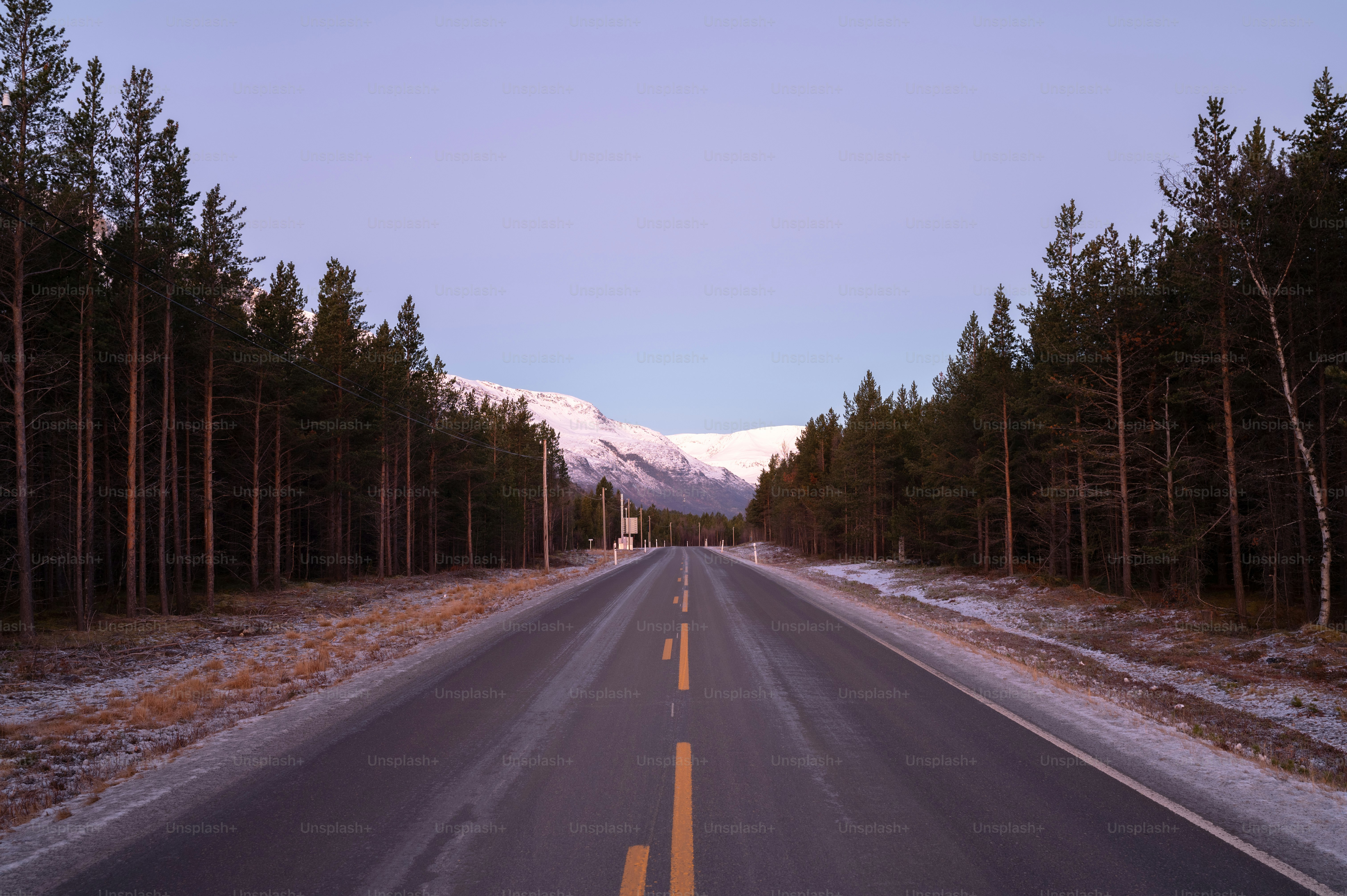 a road with a mountain in the background