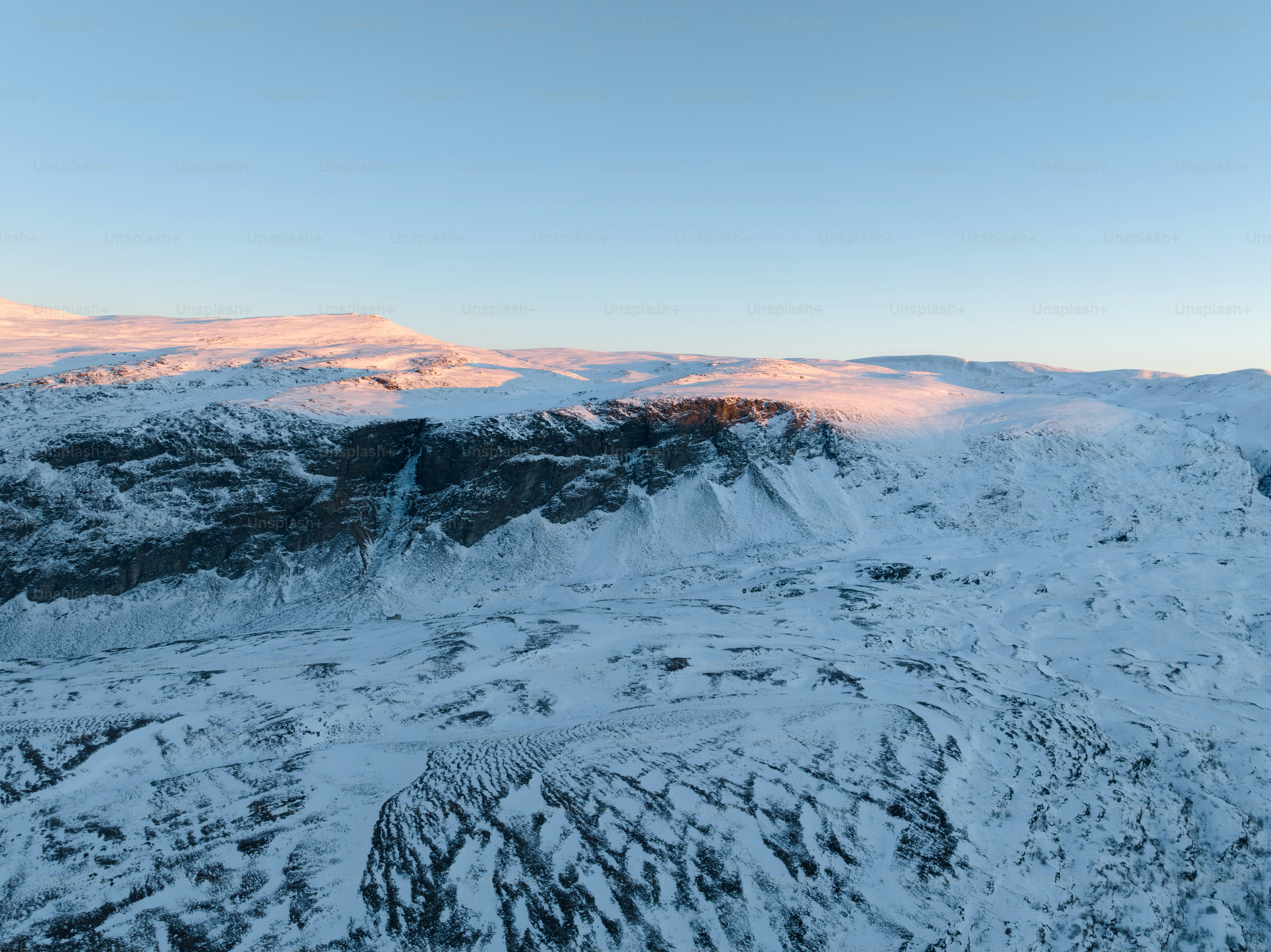 a view of a mountain range covered in snow