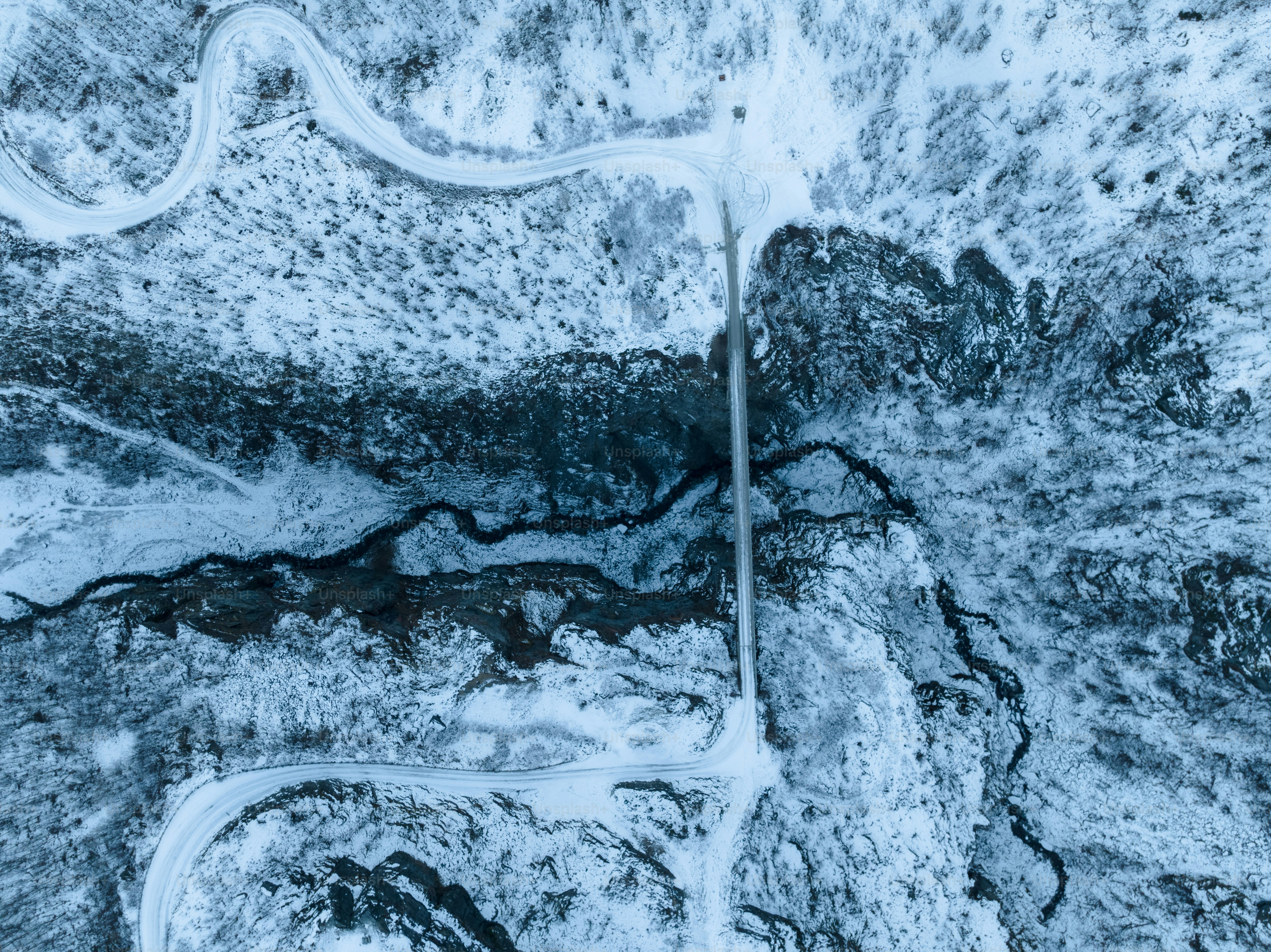 An aerial view of a road in the snow photo – Winter Image on Unsplash