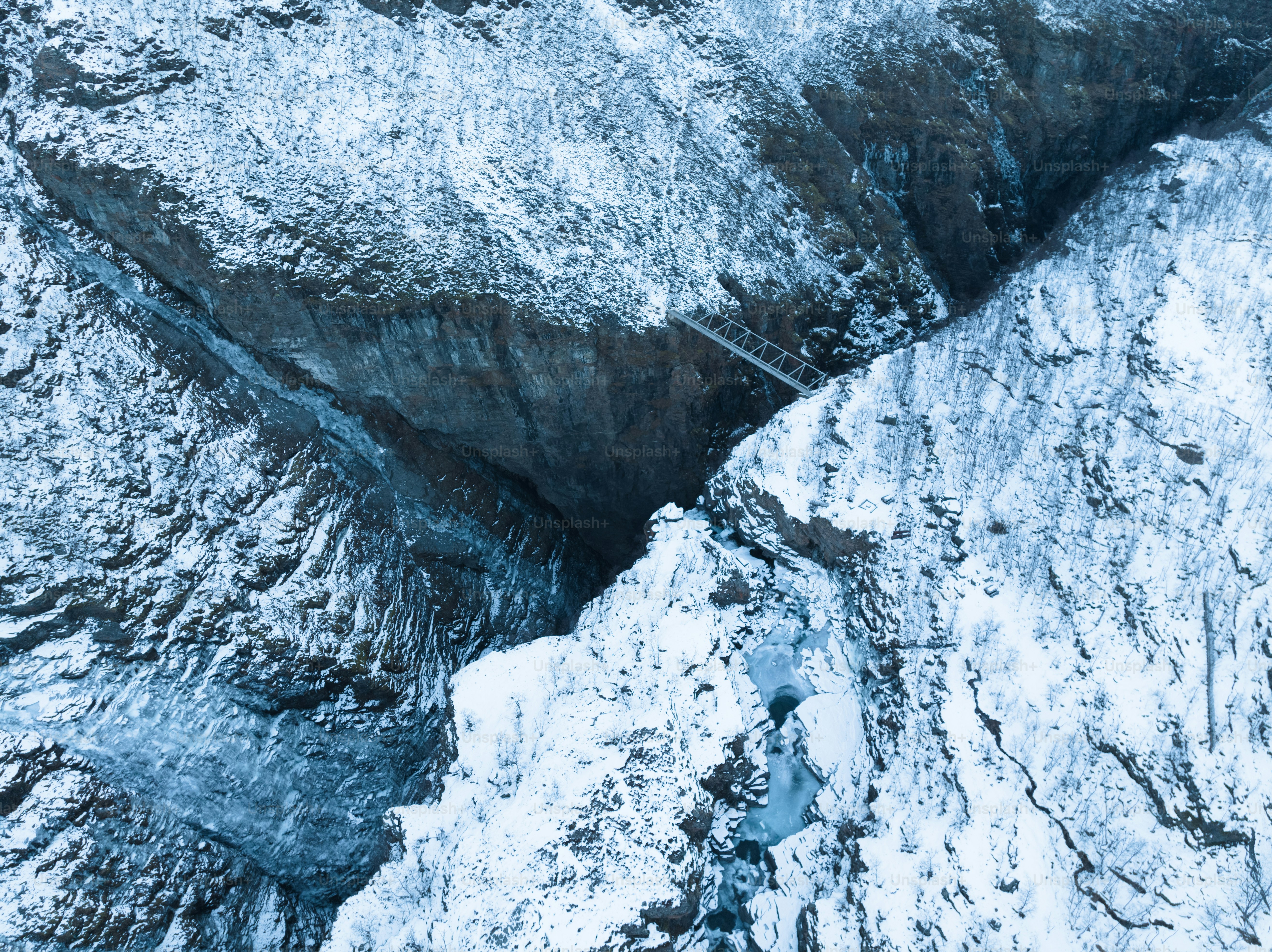 An aerial view of a snow covered mountain photo – Wallpapers Image on ...