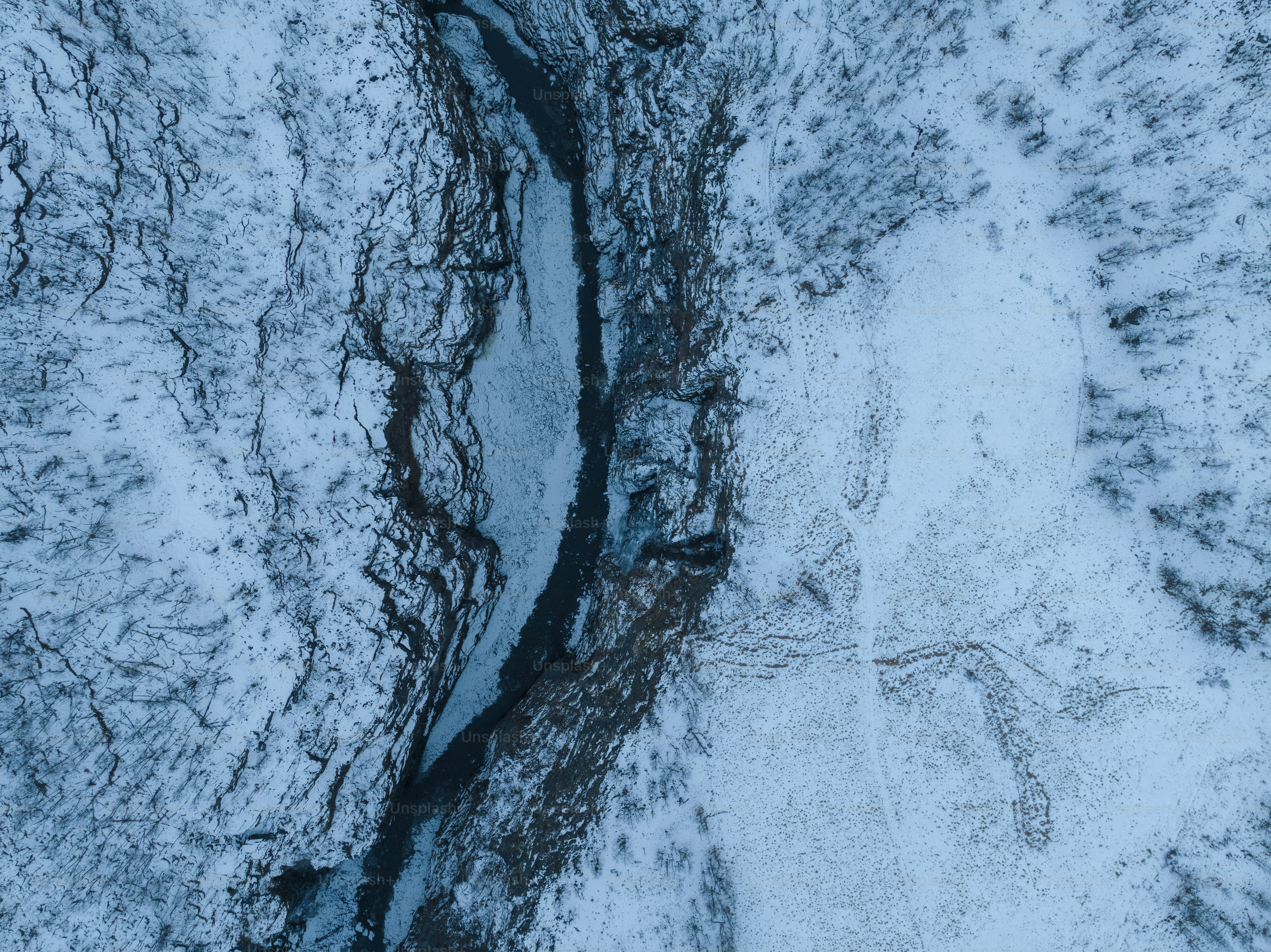 a river running through a snow covered forest