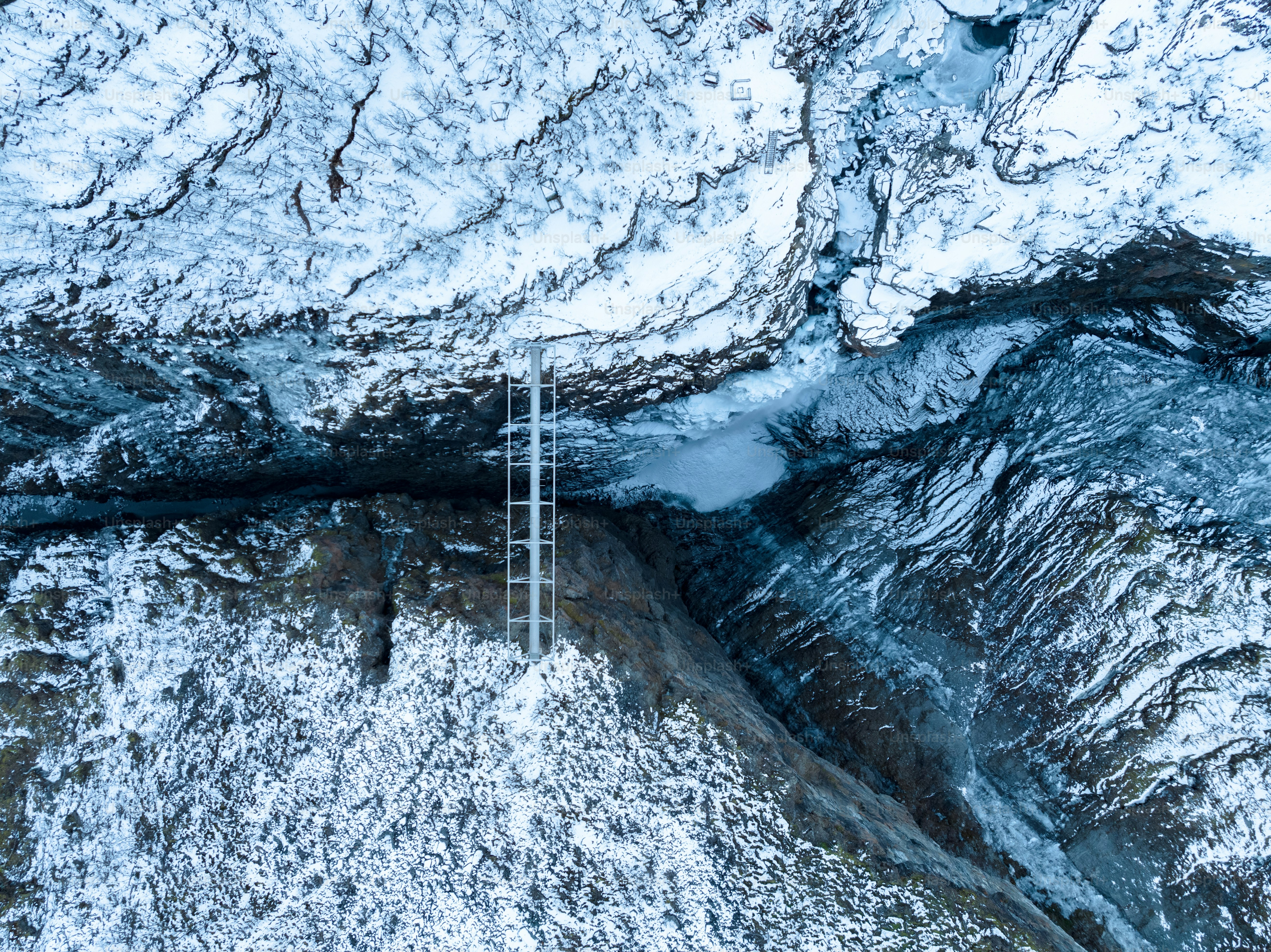 An aerial view of a snow covered mountain photo – Freezing Image on ...