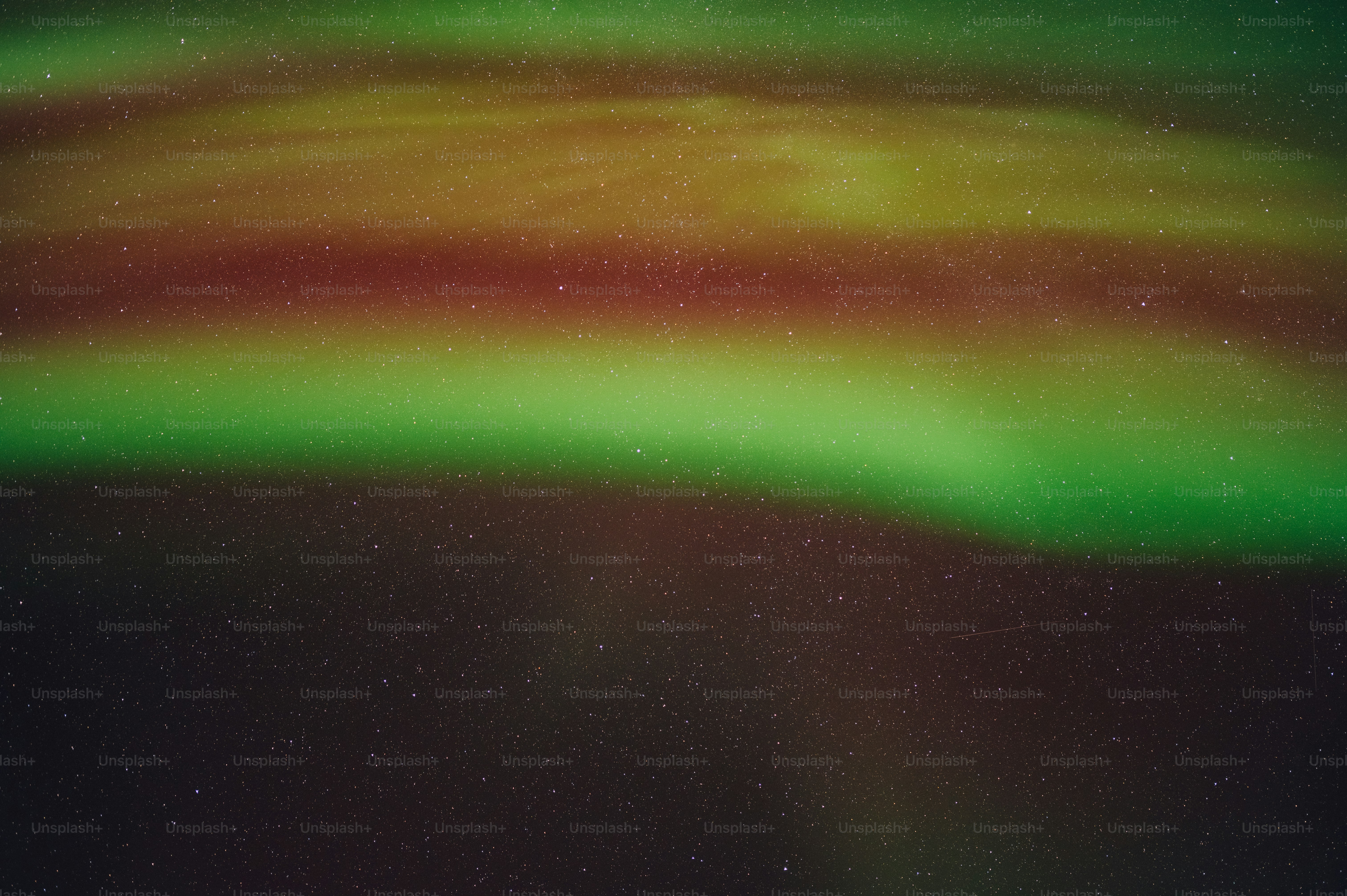 a bright green and red aurora bore in the night sky