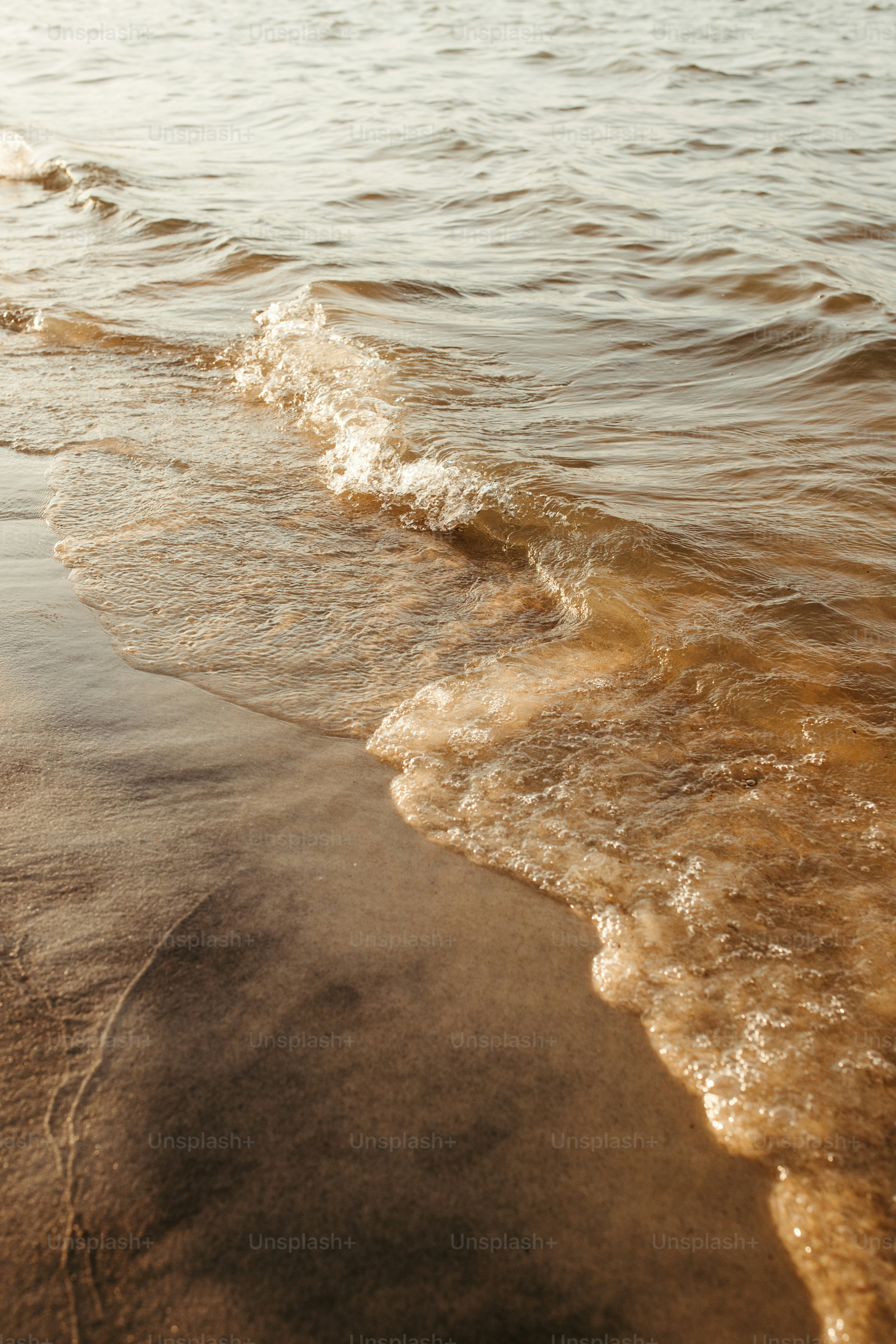 a beach with waves coming in to shore