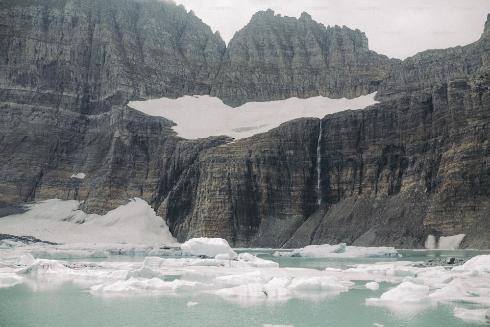 a group of mountains with a waterfall in the middle of them