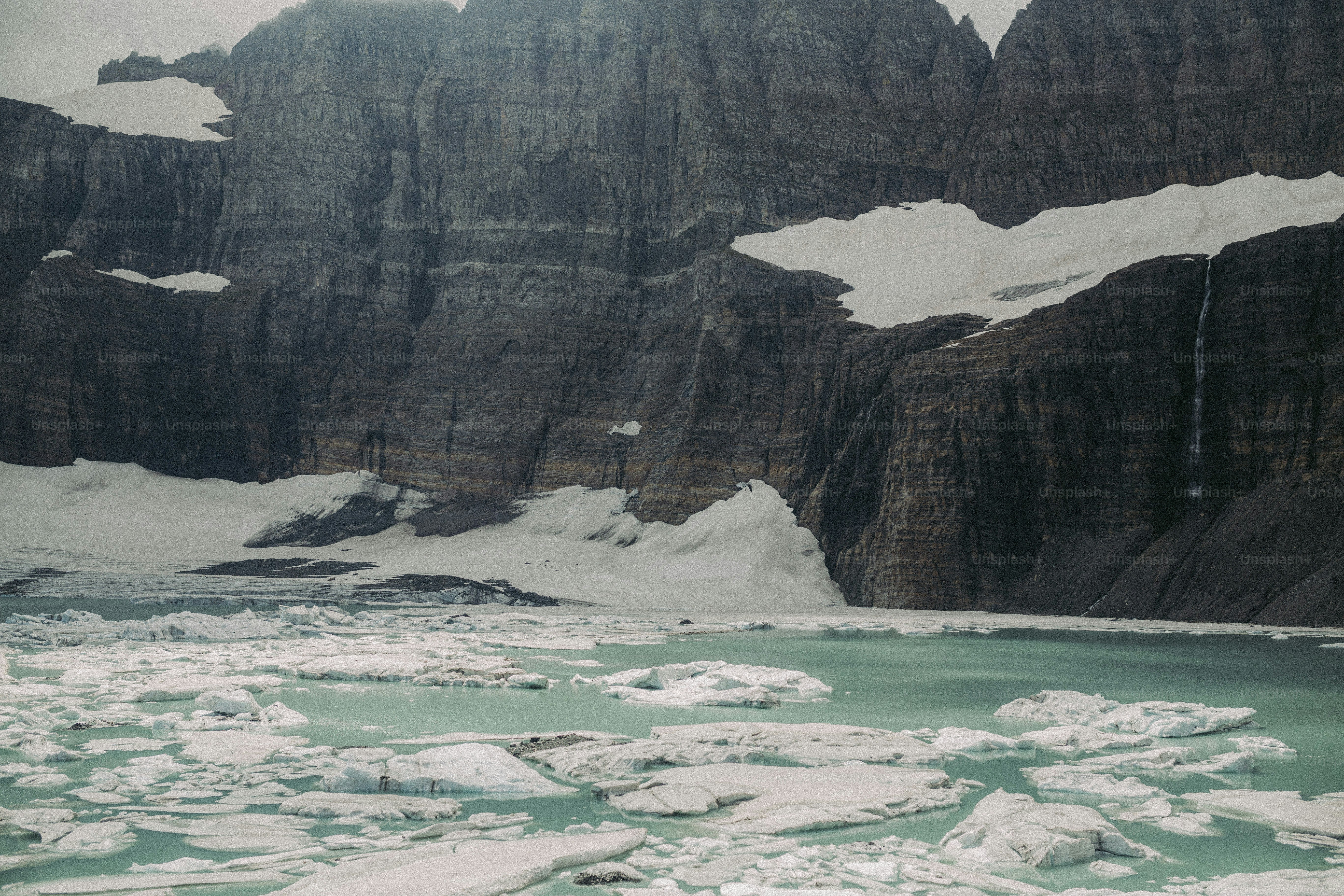 a group of mountains that are next to a body of water