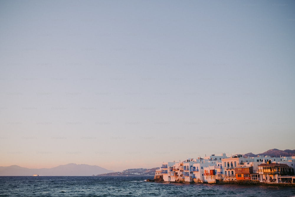 a row of houses on the shore of a body of water