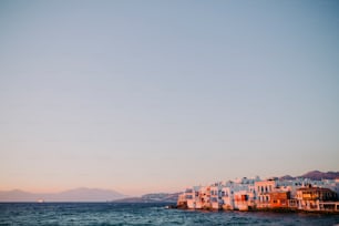 a row of houses on the shore of a body of water