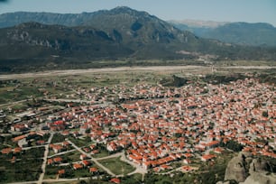 an aerial view of a city with mountains in the background