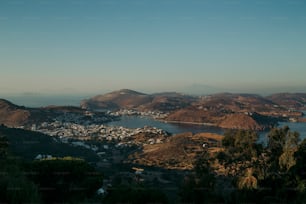 a view of a town and a lake from a hill