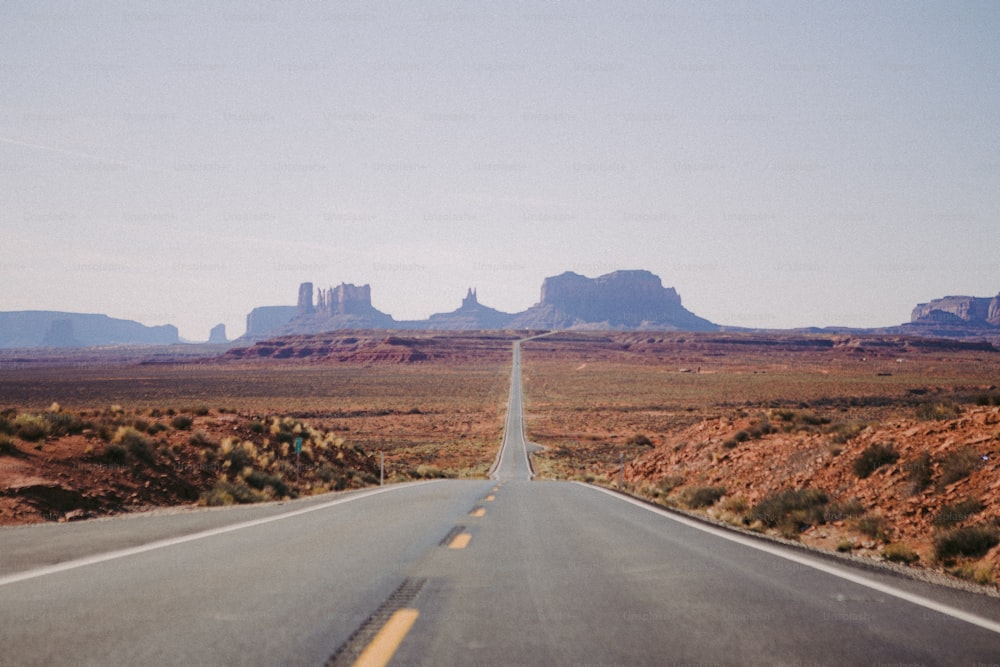 an empty road in the middle of the desert