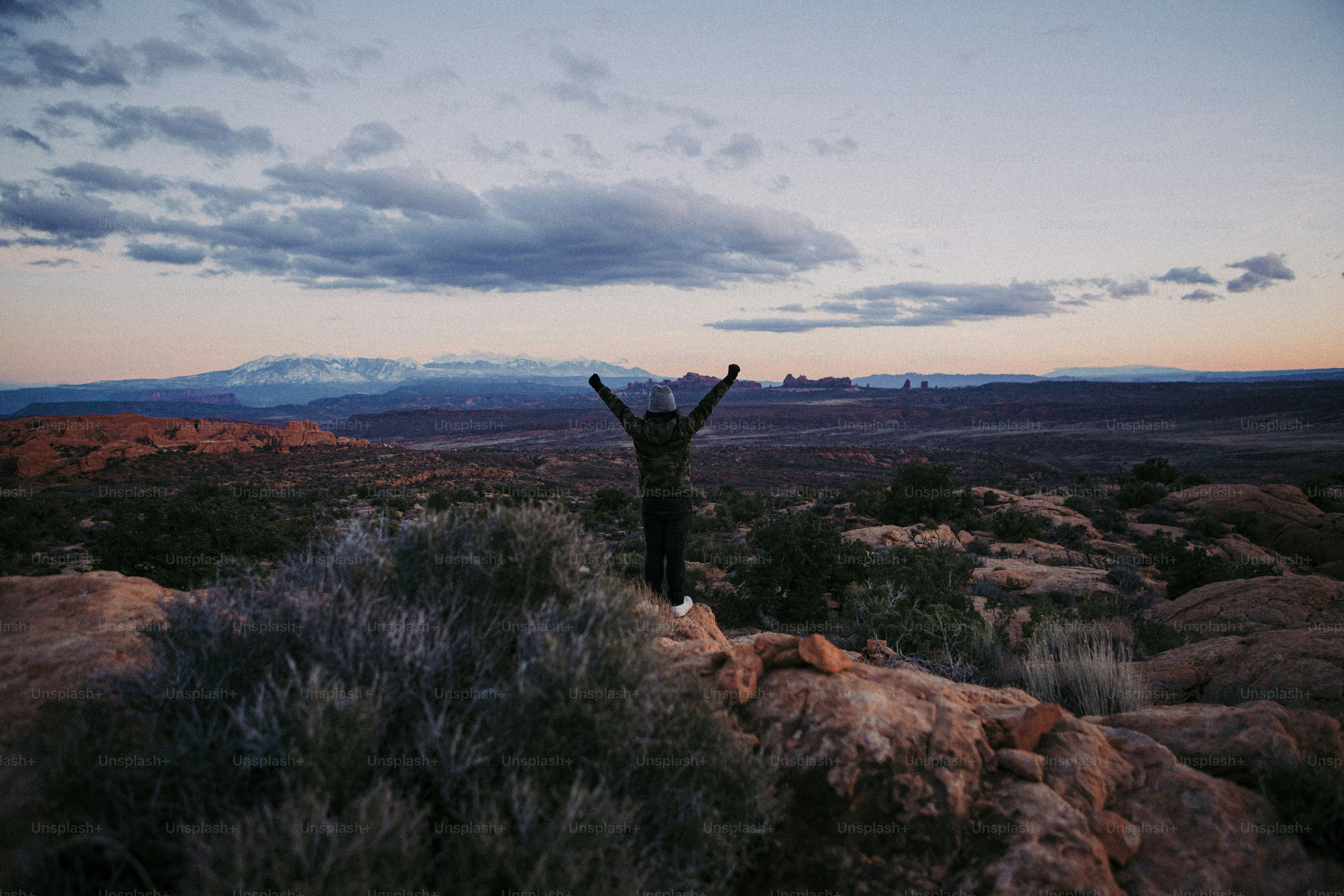 a person standing on top of a rocky hill