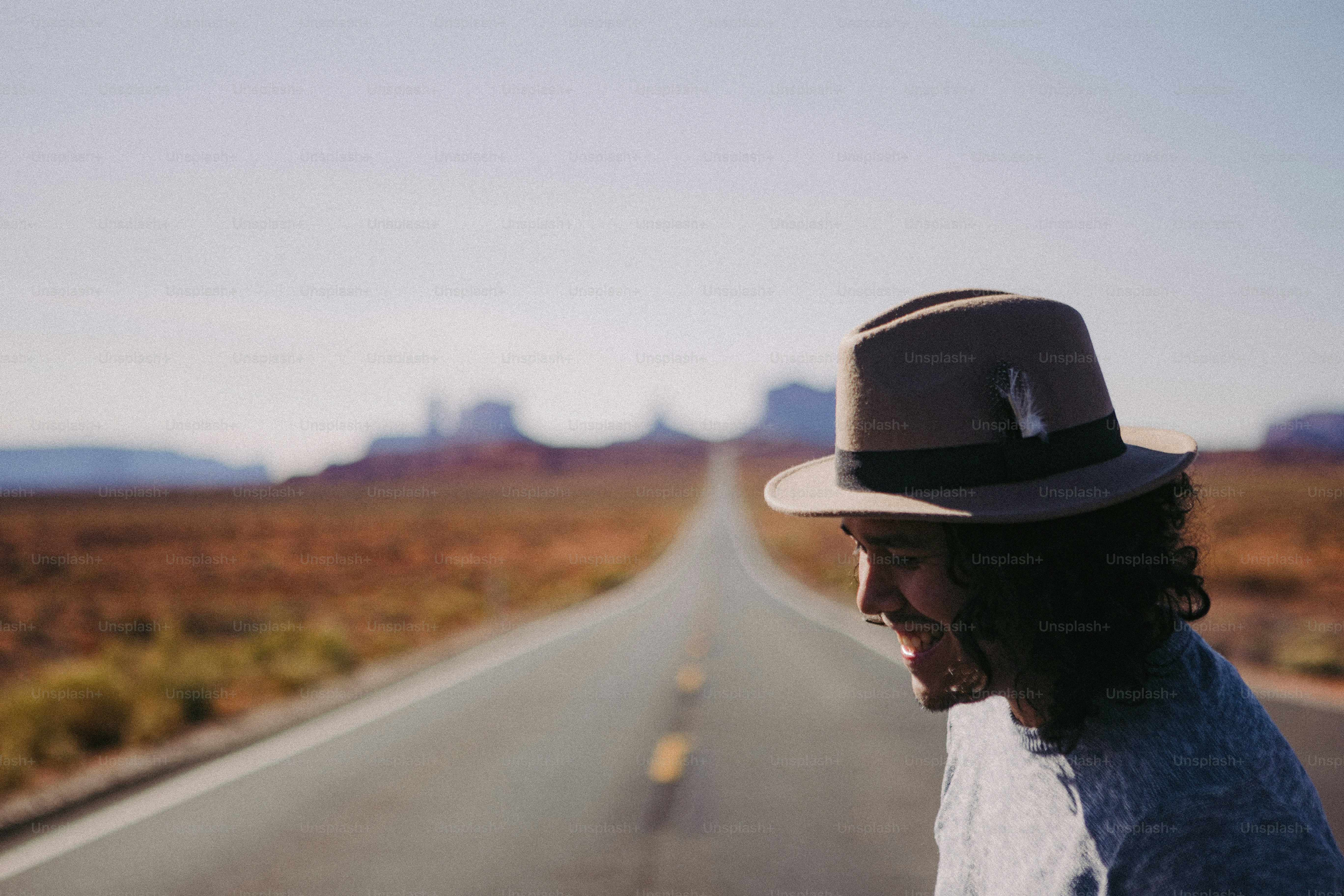 a man with a hat is riding a motorcycle