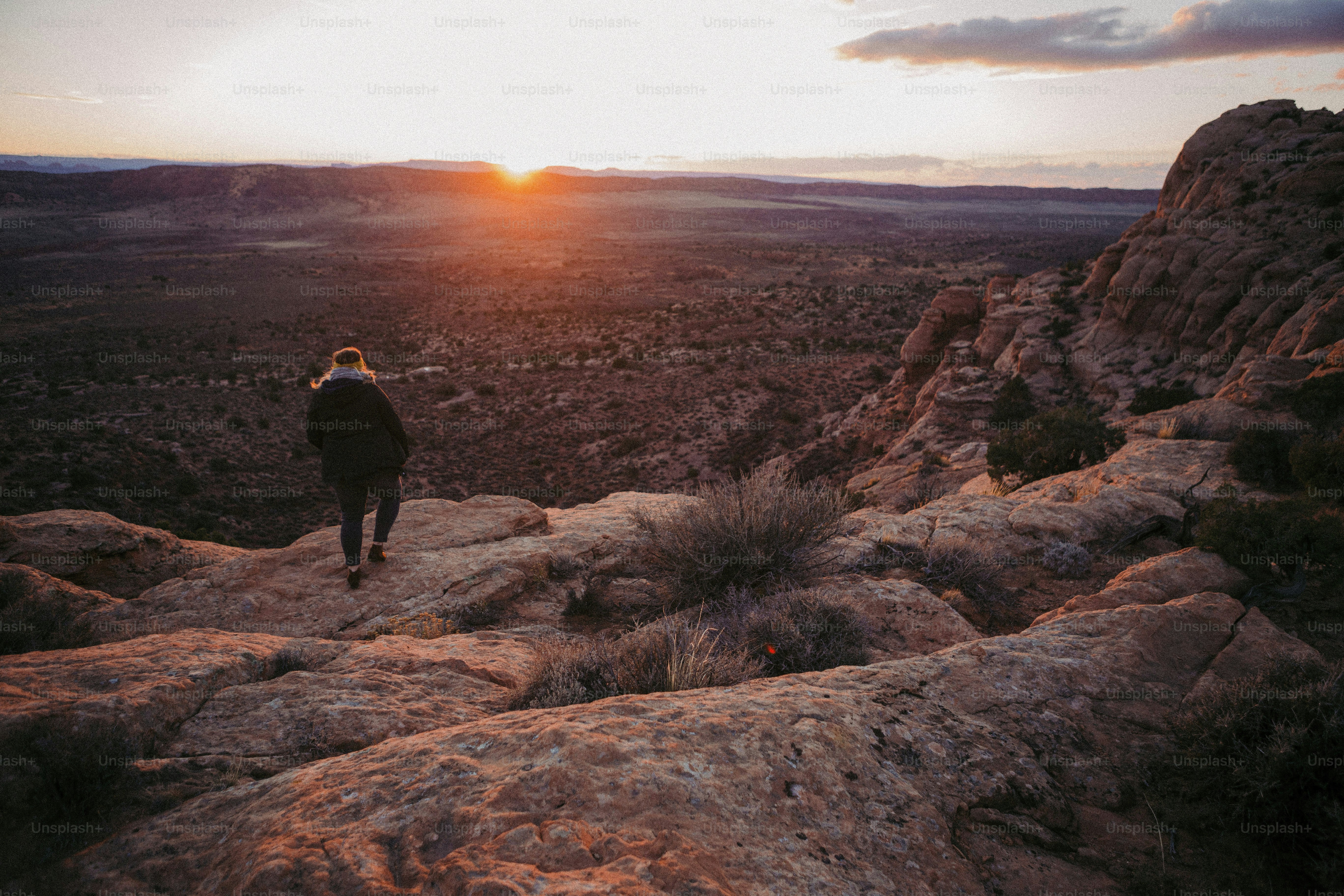 a person standing on top of a large rock