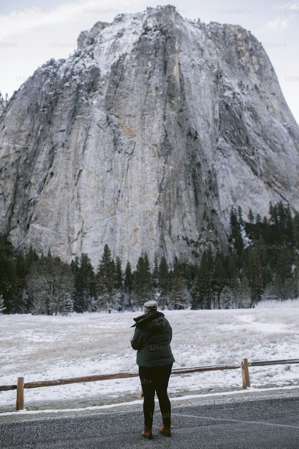 a person standing in front of a mountain