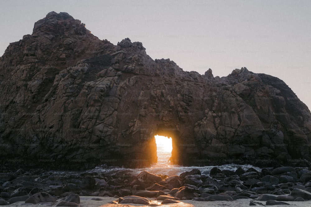 a large rock formation with a light at the end of it