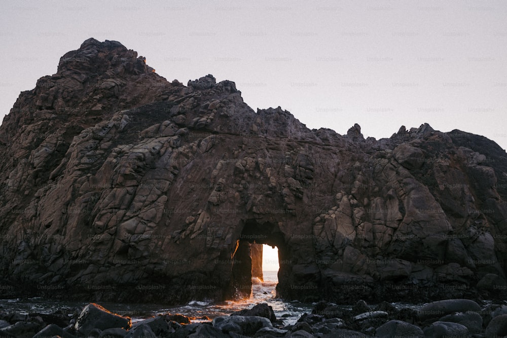 a large rock formation with a light at the end of it