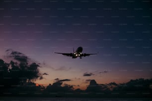 an airplane is flying in the sky over the ocean