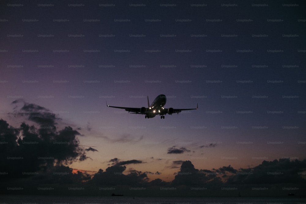 an airplane is flying in the sky over the ocean