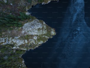 an aerial view of a body of water near a cliff