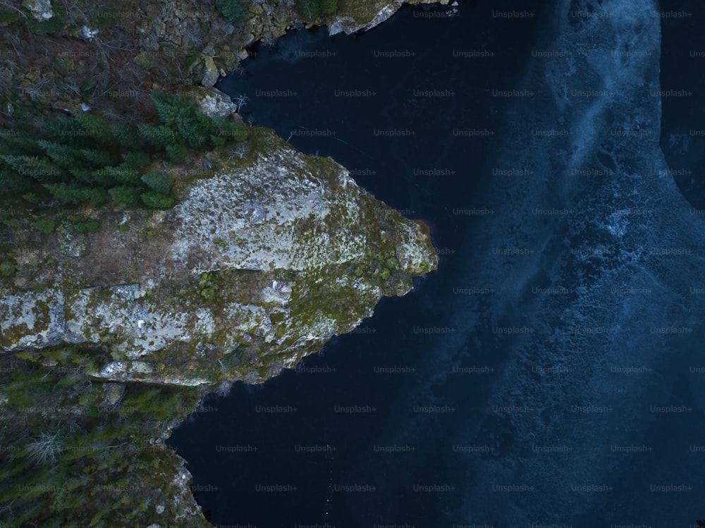 an aerial view of a body of water near a cliff