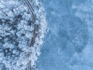 an aerial view of a train track through the snow