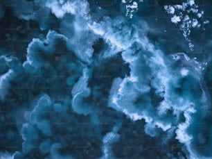 an aerial view of blue water and ice