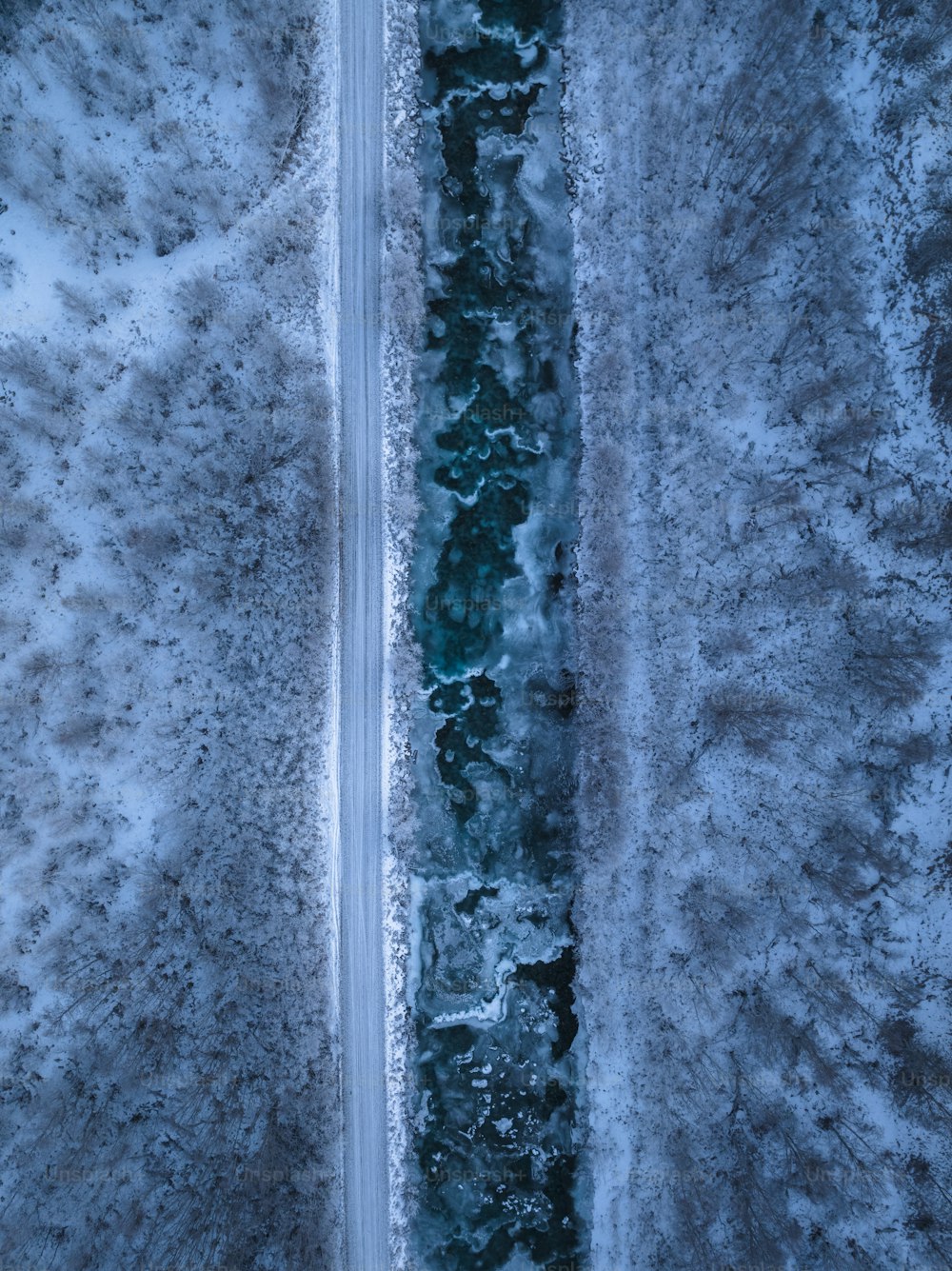 an aerial view of a road in the snow