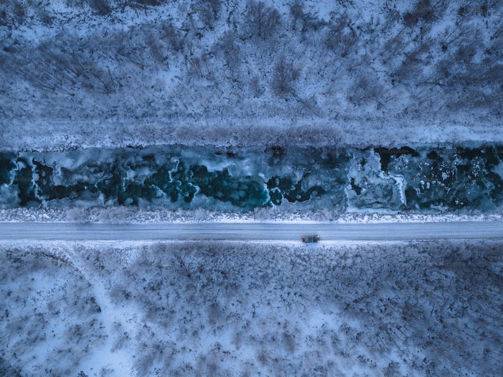 an aerial view of a road in the snow