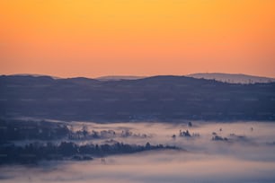 a view of a mountain range covered in fog