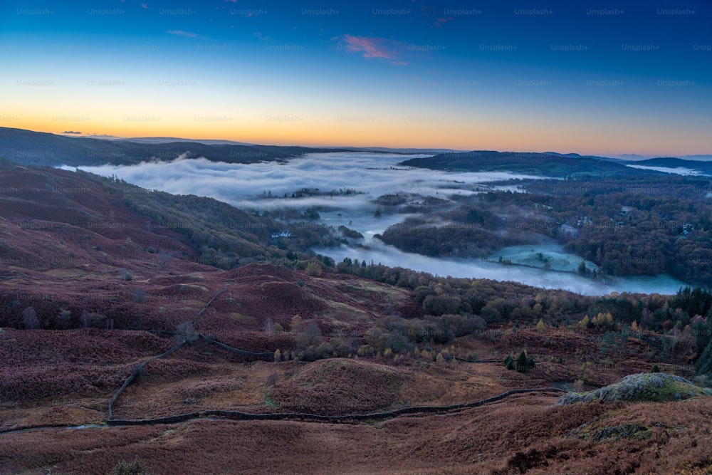a view of a valley covered in fog