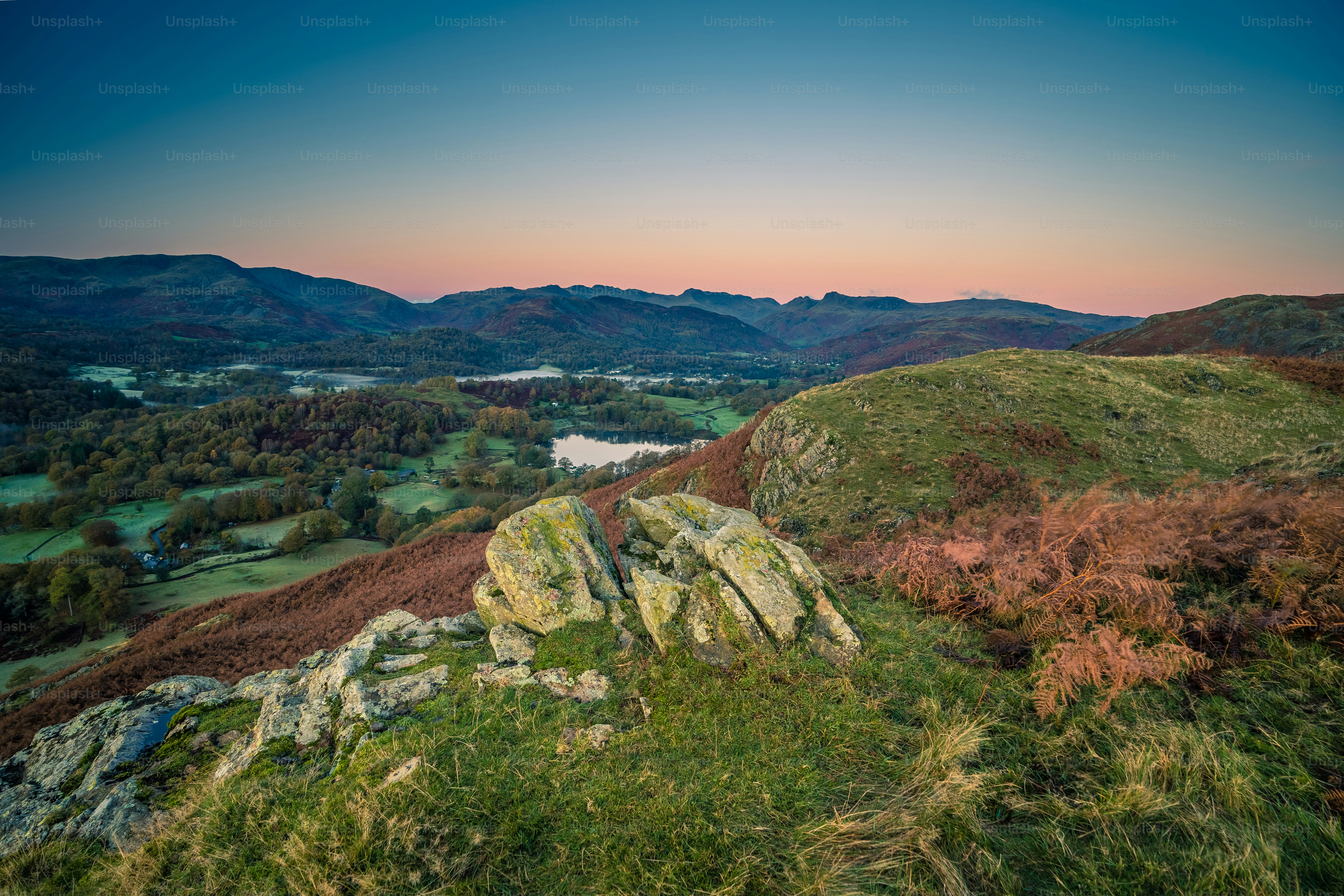 a view of a valley with mountains in the background