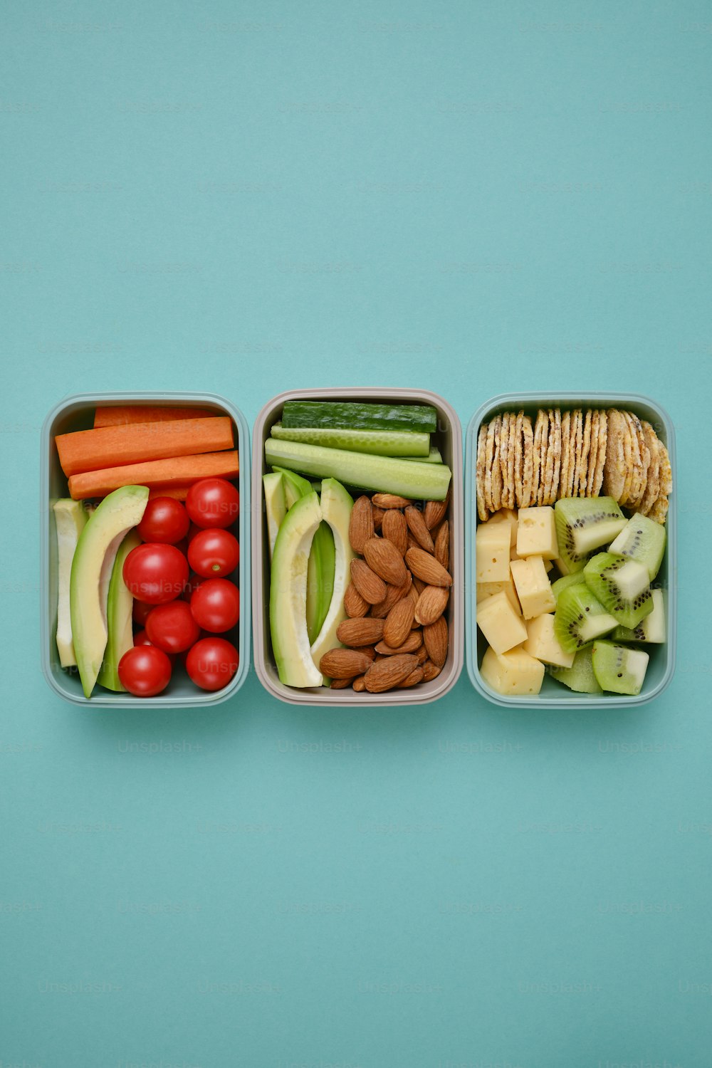 three plastic containers filled with different types of food