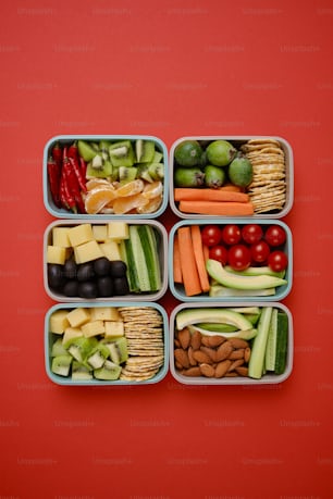 a group of four containers filled with different types of food