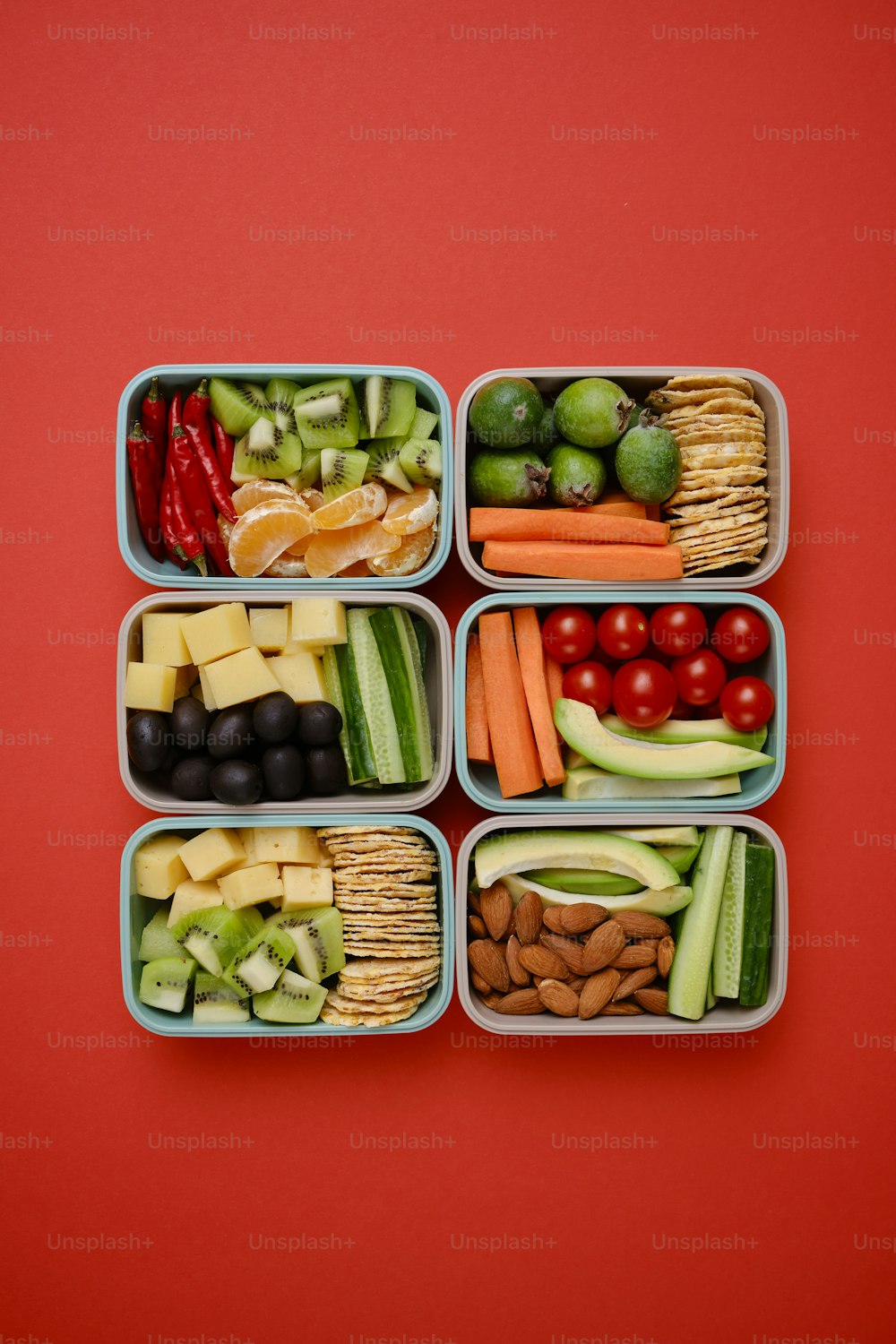 a group of four containers filled with different types of food