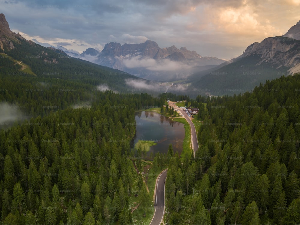 an aerial view of a road in the middle of a forest