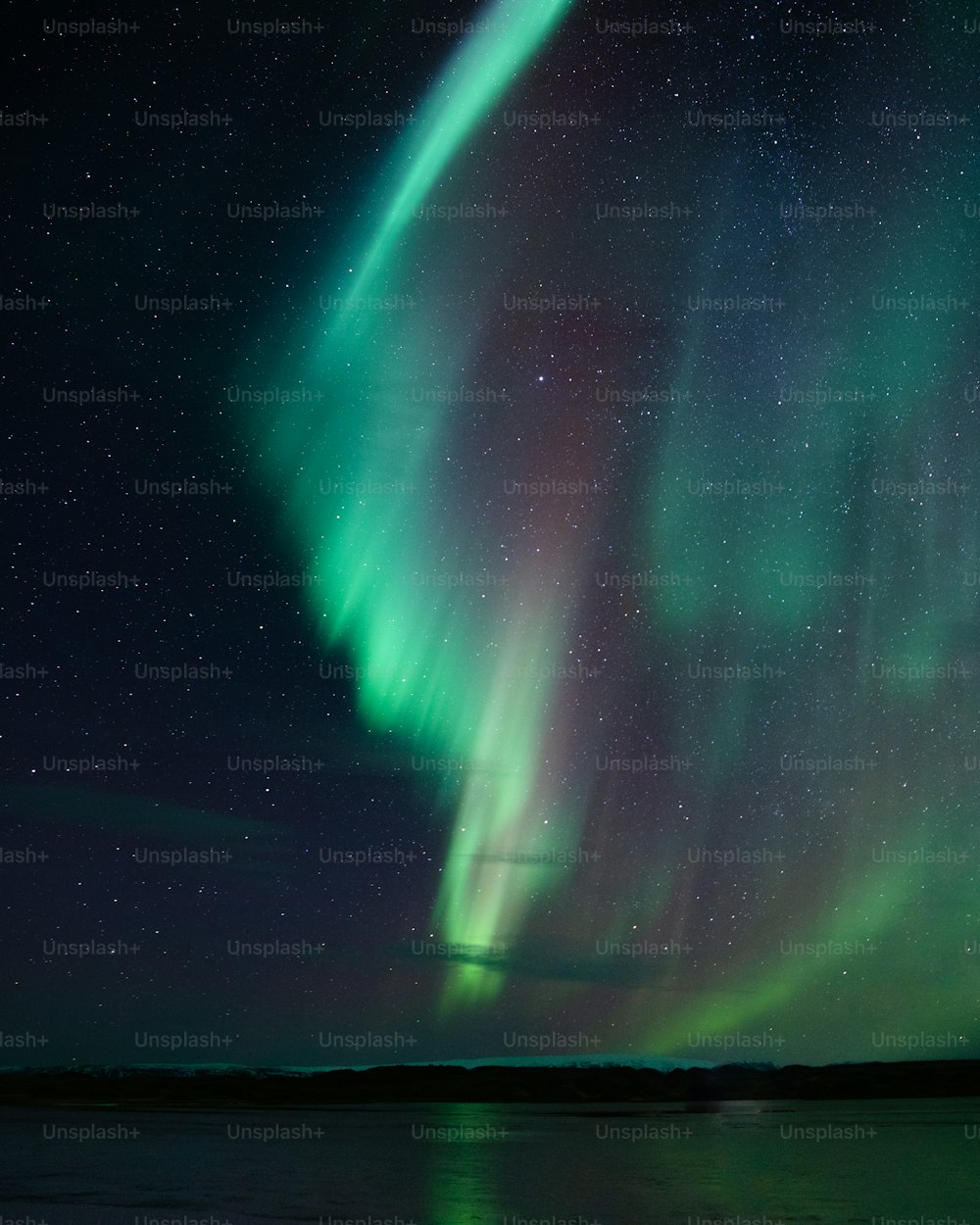 a green and purple aurora bore in the night sky