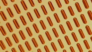 uno sfondo giallo con file di pillole arancioni
